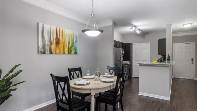 Bright dining area with four-seat table and modern lighting at Lauren Ridge Apartment Homes
