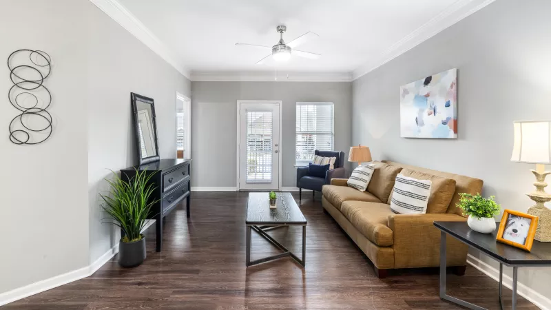 Spacious living room with wood-style flooring and natural light at Lauren Ridge Apartments.