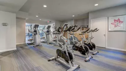 Cardio zone at The Saulet apartments in New Orleans with stationary bikes and exercise machines in a clean, modern space.