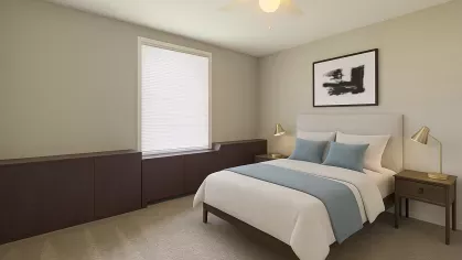 Virtually staged second bedroom showcasing a queen bed with blue accents, two gold bedside lamps, and dark built-in cabinetry under the window.