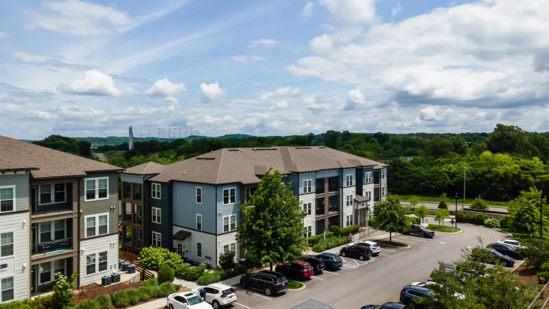 Stone-accented garages and apartment homes at Avery at Turkey Creek community