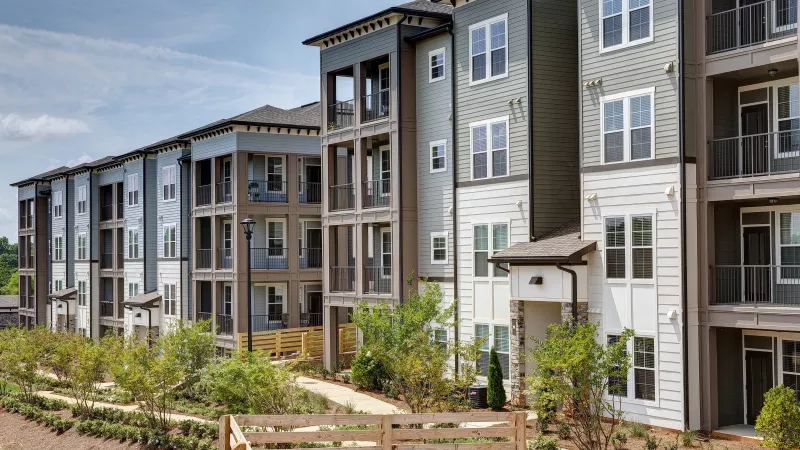 Row of Avery at Turkey Creek apartment homes with modern siding and outdoor patios