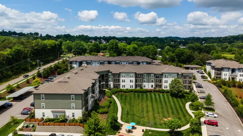 Aerial view of Avery at Turkey Creek apartments with large green lawn and walking paths