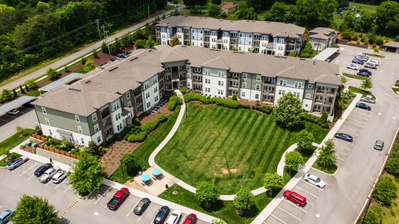 Drone photo of Avery at Turkey Creek community with landscaped courtyards and modern apartment homes