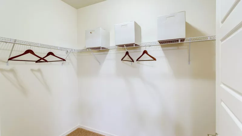 Spacious walk-in closet with shelving and storage space at Avery Turkey Creek Apartments.