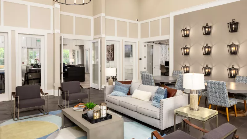 Stylish resident lounge at Avery Turkey Creek featuring modern sofas, accent lighting, and a cozy atmosphere.