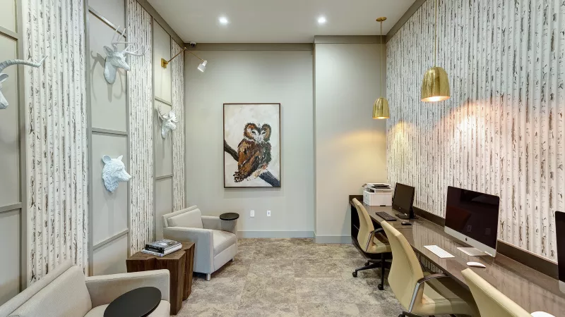 Resident business center at Avery Turkey Creek with computers, seating, and modern lighting.