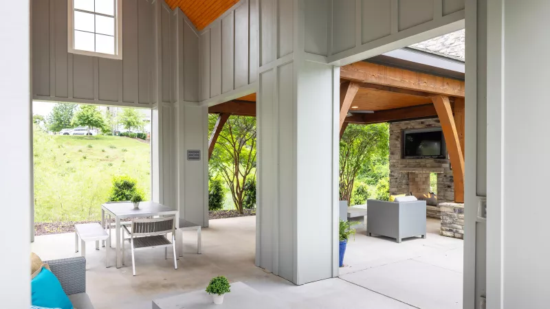 Pavilion at Avery apartments showcasing open design with dining tables and lounge seating.