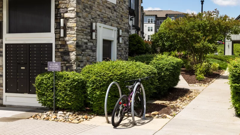 Outdoor bike rack with resident bicycle beside mailboxes at Avery at Turkey Creek Apartments.