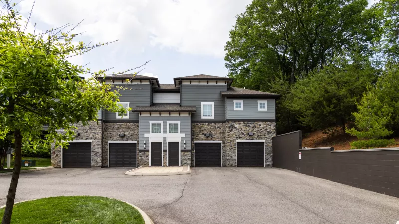 Avery at Turkey Creek townhome-style buildings with attached garages and stone façade.