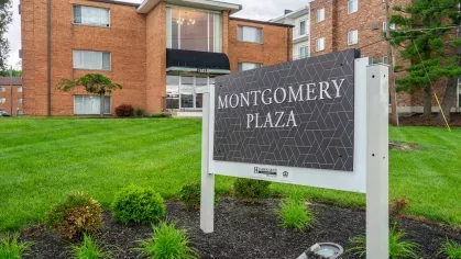 Street-level view of Montgomery Plaza Apartments with nearby retail and pedestrian-friendly access in Cincinnati, OH
