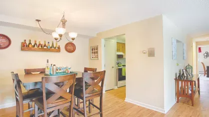 Royal Crest Estates Marlboro dining area with modern lighting – Comfortable dining space with wood dining set, overhead chandelier, and easy access to the kitchen.
