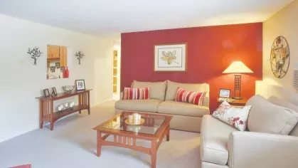 Royal Crest Estates Marlboro living room with accent wall – Comfortable living area featuring plush carpet, accent wall, and stylish modern furniture.