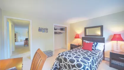 Royal Crest Estates Marlboro bedroom with desk space – Spacious bedroom with twin bed, work desk, closet space, and natural lighting, ideal for studying or remote work.