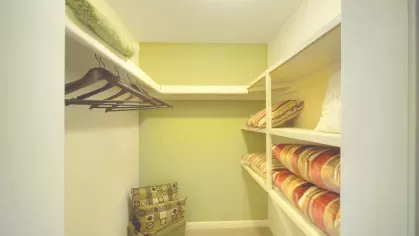 Walk-in closet with shelving – Spacious walk-in closet with built-in shelving, storage baskets, and hanging rods in a Royal Crest Estates Marlboro apartment.