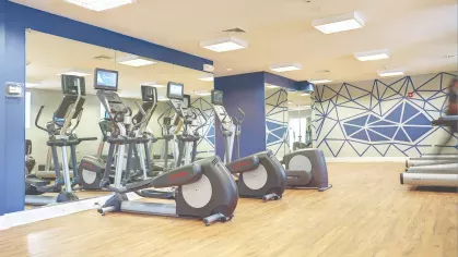 Fitness center cardio equipment – Modern fitness center with treadmills, ellipticals, and mirrored walls at Royal Crest Estates Marlboro.
