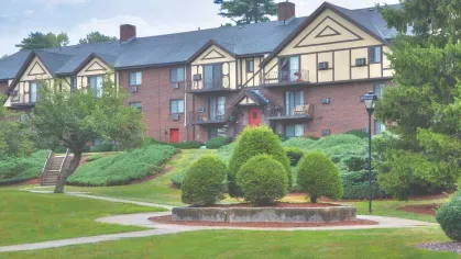 Tudor-style apartment buildings with balconies and landscaped grounds at Royal Crest Estates Marlboro