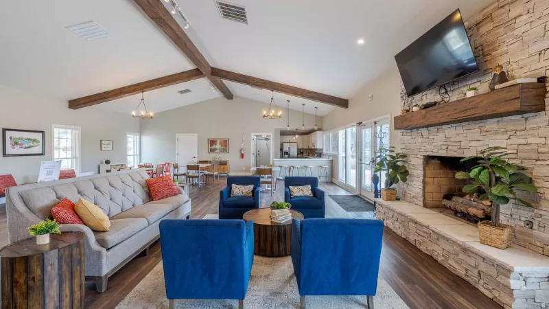 Expansive clubhouse with comfortable, ample seating and TVs for residents to enjoy.