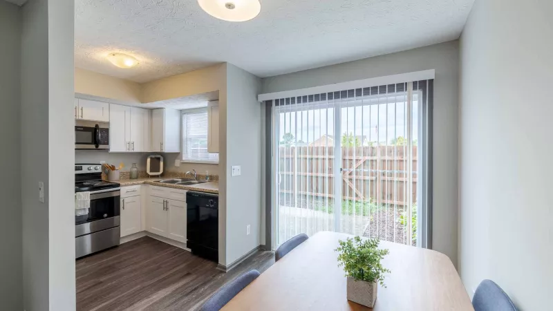Kitchen nook connected to the kitchen area with a sliding-glass door overlooking the outdoor area.
