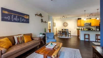 Large living room with access to the kitchen and eating area. 