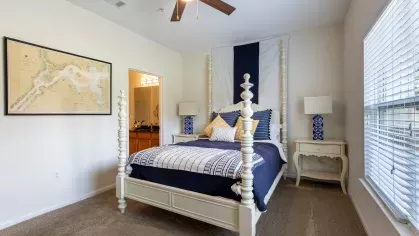 Bright, open bedroom with attached bathroom.