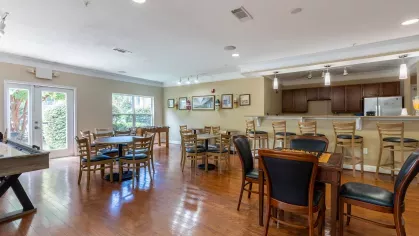 Large clubhouse area with ample amount of seating and a shuffleboard for residents to enjoy.