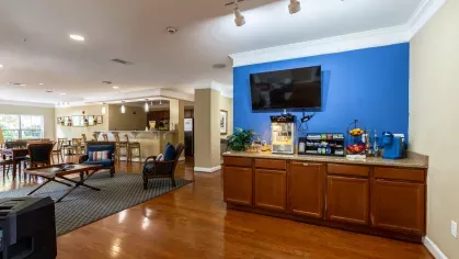 Clubhouse area with a designated popcorn machine, fresh fruit and snacks, and coffee for residents to enjoy.