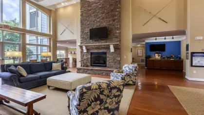 Fireplace within the clubhouse with comfortable seating surrounding it. 