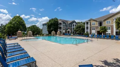 Lounge chairs available surrounding the swimming pool and hot tub area.
