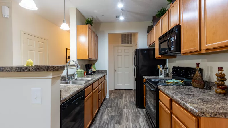 Market Street Station large kitchen with black appliances and granite countertops. 