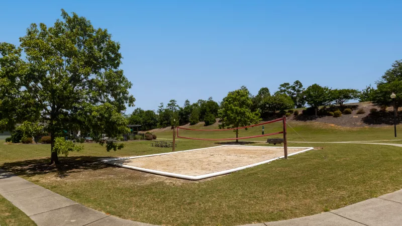Outdoor sand volleyball area for residents to play.