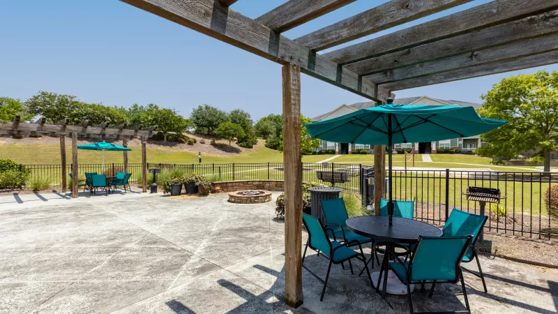 Outdoor seating located conveniently near the resort style swimming pool.