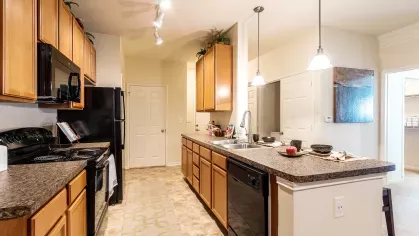 Bright, open kitchen with ample amounts of storage and upgraded appliances.