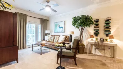 Open living room with ceiling fan and room for residents to relax.