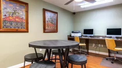 Clubhouse that includes area for residents to use complimentary computers.