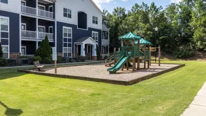 Updated playground space with playground equipment for residents to play on.