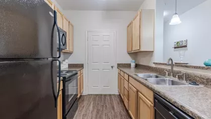 Updated kitchen with ample cabinet space and bright overhead lighting.