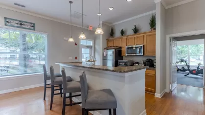 Clubhouse kitchen with upgraded appliances, such as stainless steel fridge, microwave, and oven. 