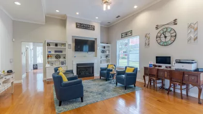 Clubhouse with ample seating, dedicated computer space, and large fireplace. 