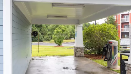 Car washing station with complimentary vacuuming area and hose. 