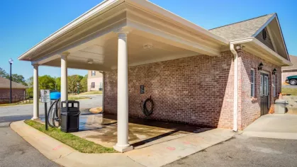 Covered car care center with vacuum and wash station for residents within the apartment community.