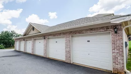 Row of attached private garages offering convenient parking options for apartment residents.