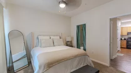 Large primary bedroom with overhead lighting and ceiling fans.