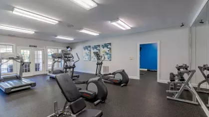 Fitness center with multiple machines for residents to use.