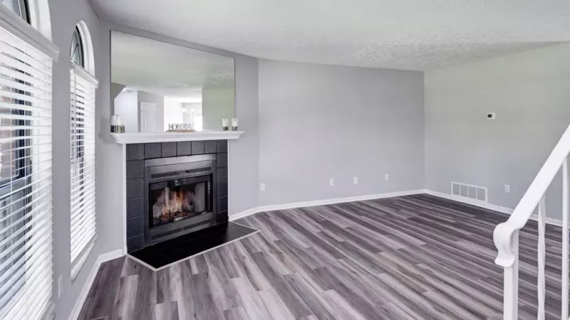 Living room with fireplace and easy access to the stairs to go to the second level.