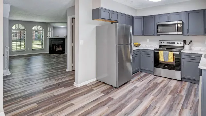 Bright, open concept kitchen with view of living room.