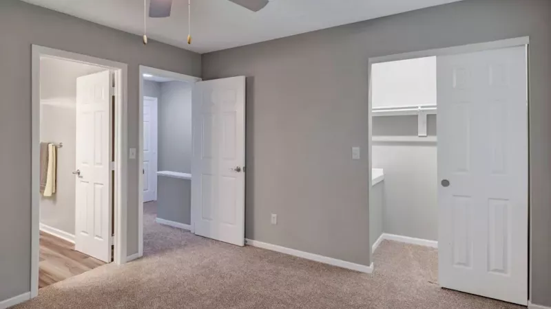 Large bedroom with attached bathroom, and spacious walk-in closet.