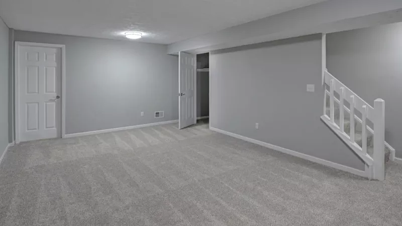 Open concept living room with access to the staircase.