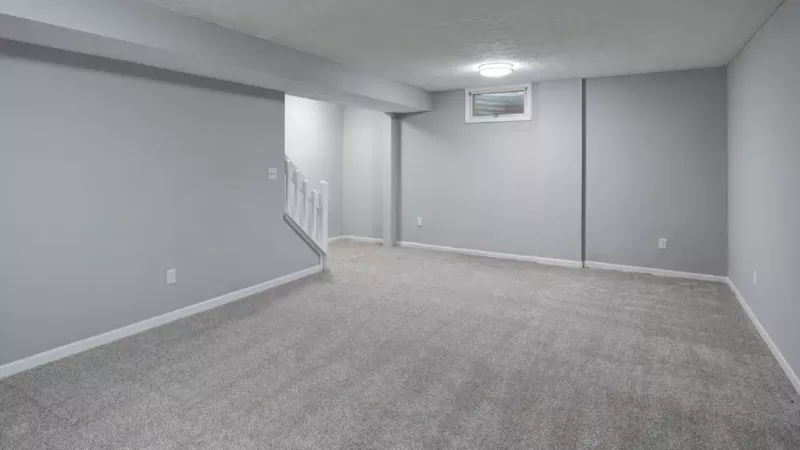 Bright, open room with access to the staircase.