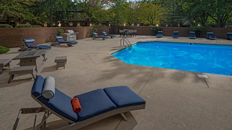Relaxing lounge chairs located near the resort style swimming pool.